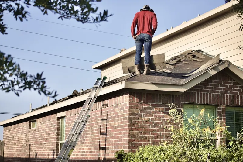 Professional roofer working on a residential roof in Bradford